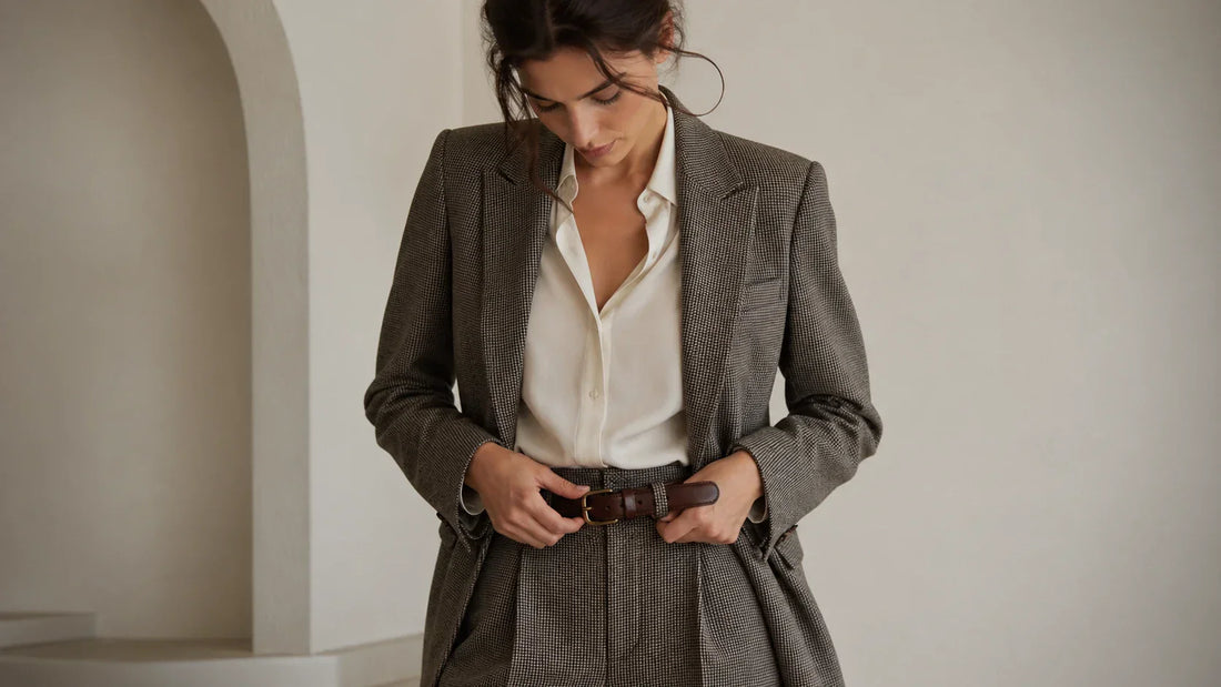 Woman fastening a leather belt at the center hole with a balanced tail length