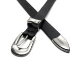 Close-up of the silver buckle, metal keeper, and pointed tip on a black slim casual belt