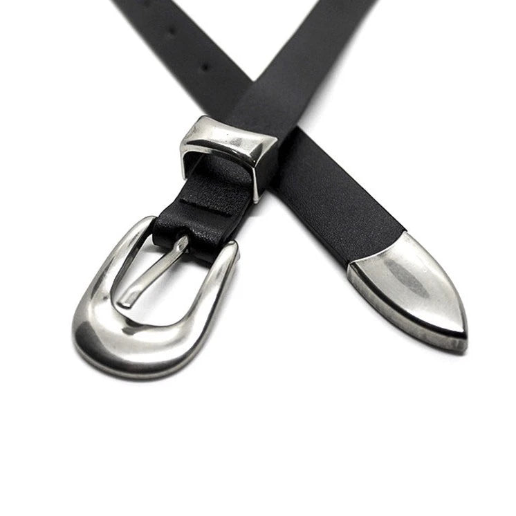 Close-up of the silver buckle, metal keeper, and pointed tip on a black slim casual belt
