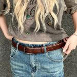 Brown classic dress belt styled with blue jeans for a casual everyday look