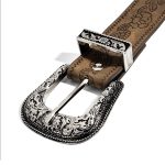 Close-up of the engraved buckle and floral embossed strap on a casual belt