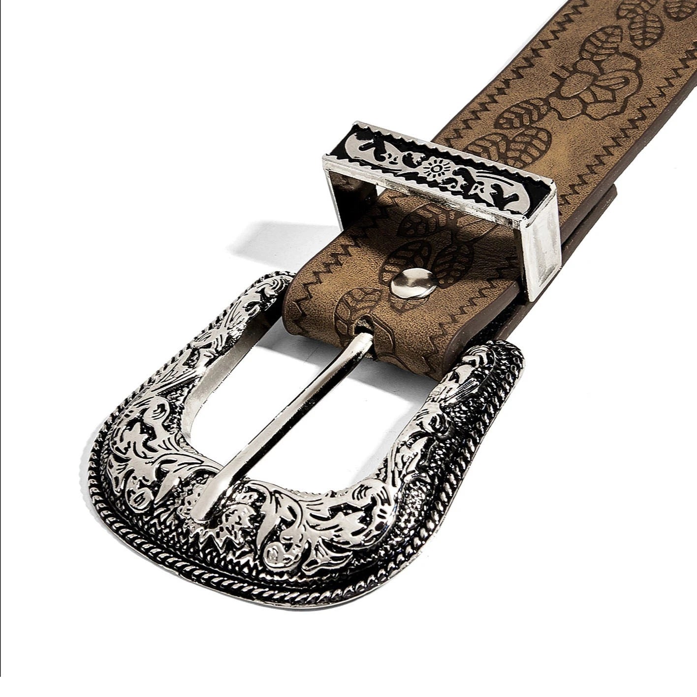 Close-up of the engraved buckle and floral embossed strap on a casual belt