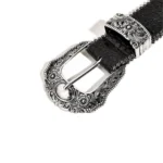 Close-up of the engraved silver alloy pin buckle on a black croc-embossed belt for women