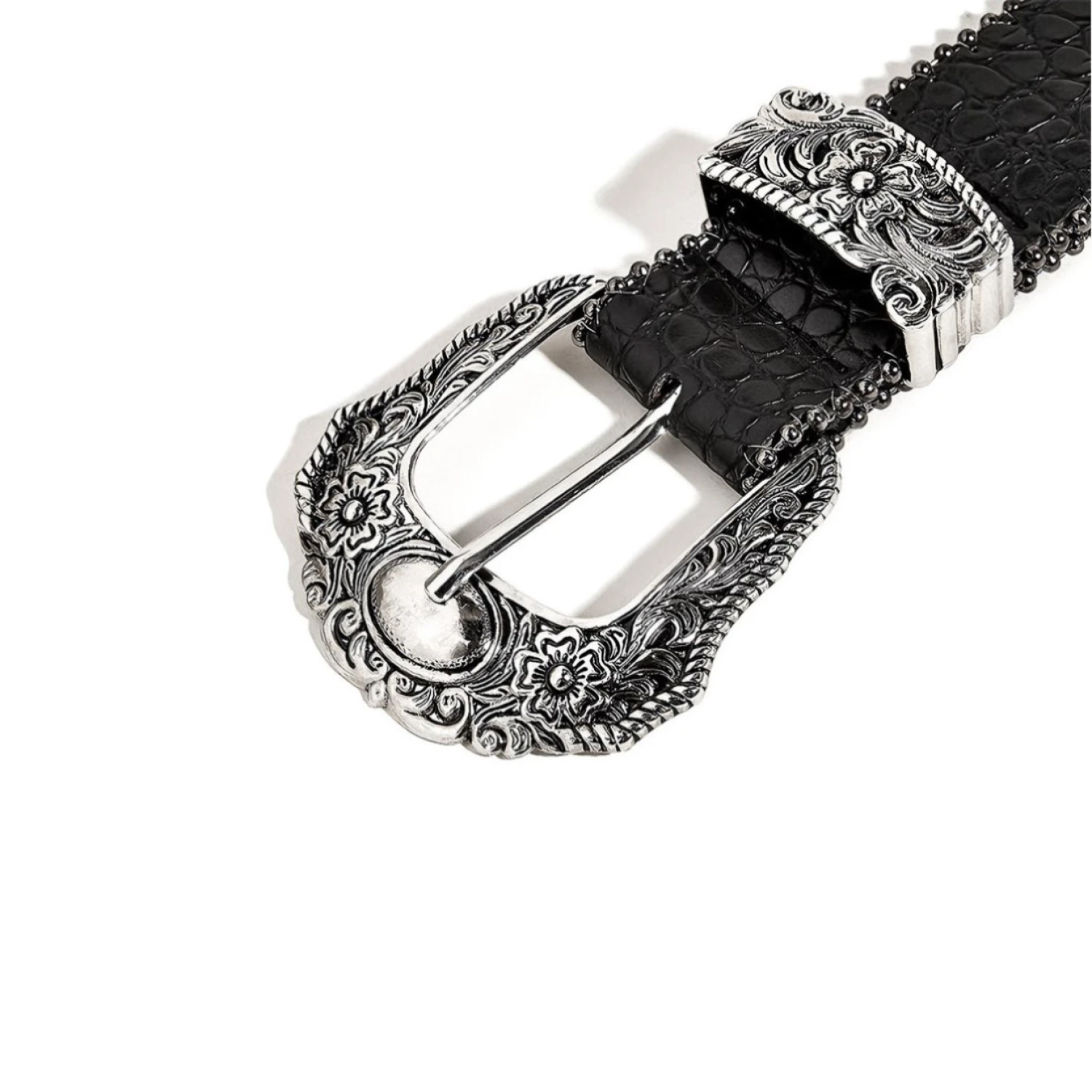 Close-up of the engraved silver alloy pin buckle on a black croc-embossed belt for women