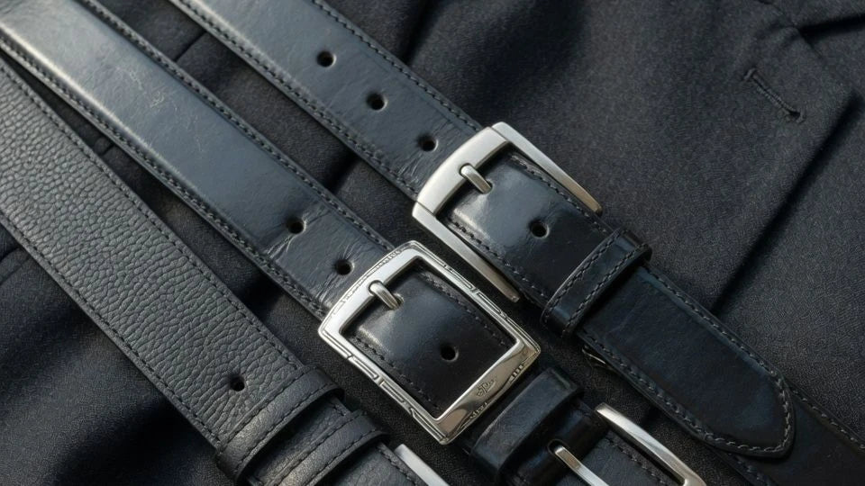 Close-up of black belt leather finishes and buckle hardware details