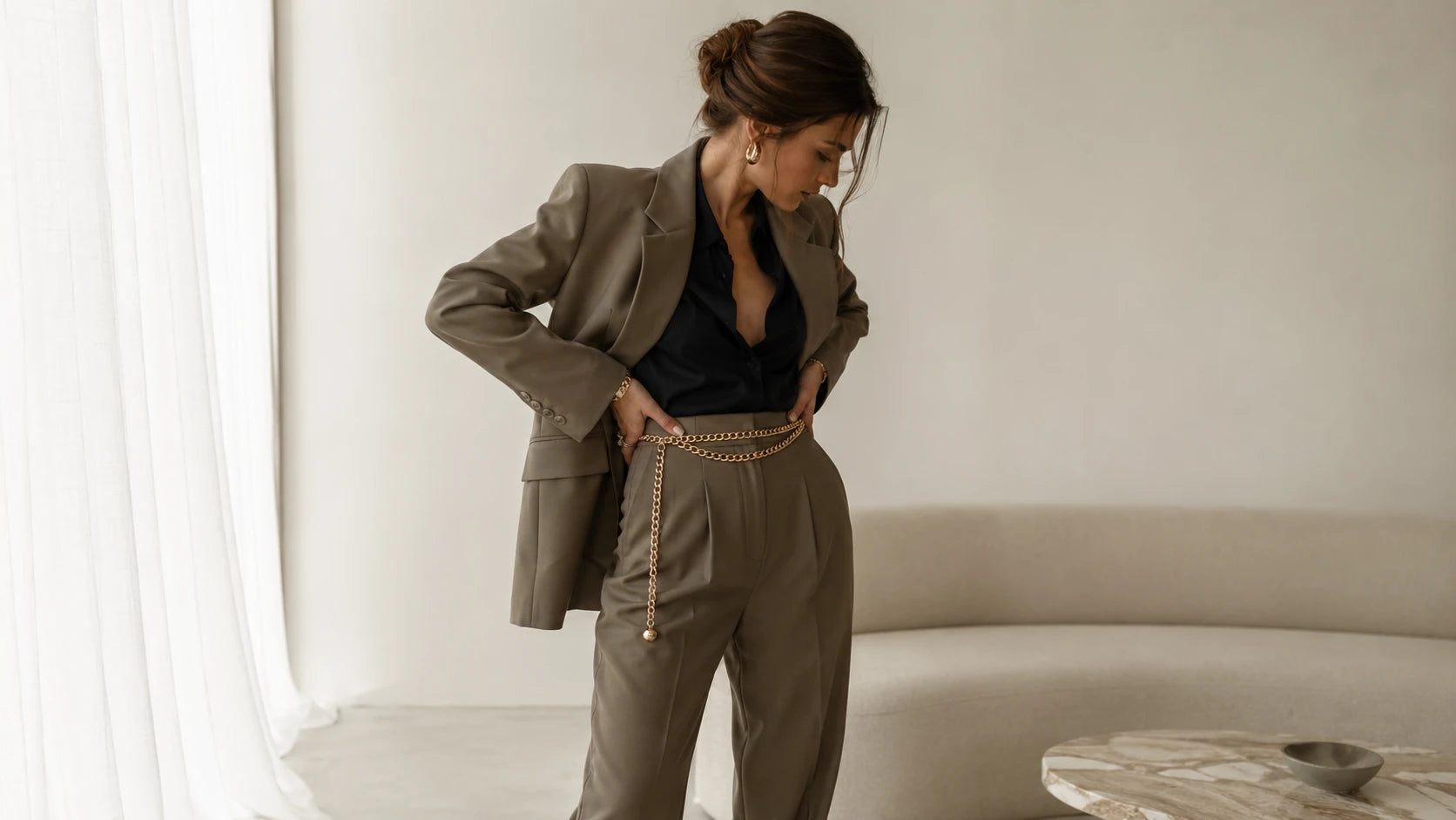 Side view showing how a chain belt affects outfit proportion and drop length